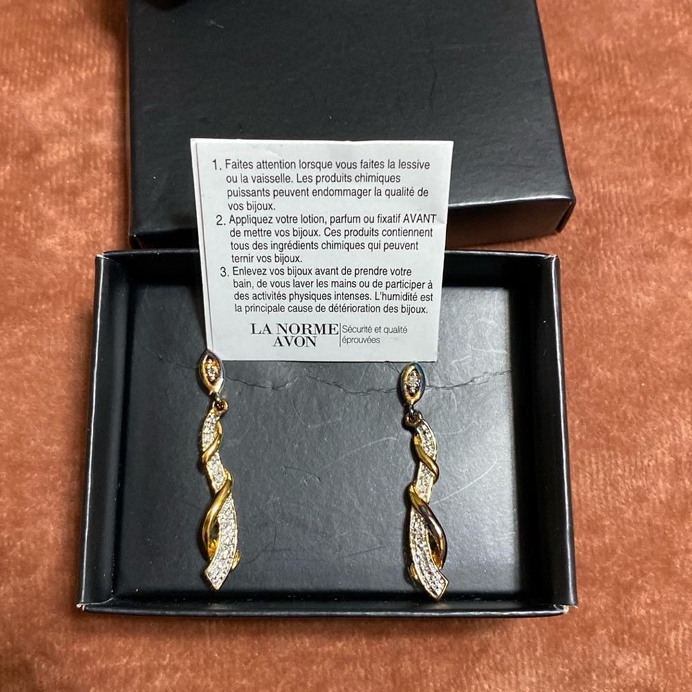 Avon earrings brand new in box. Gold and silver tone.Dangling earrings.